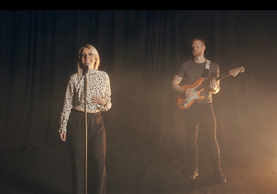 Singer and electric guitarist standing